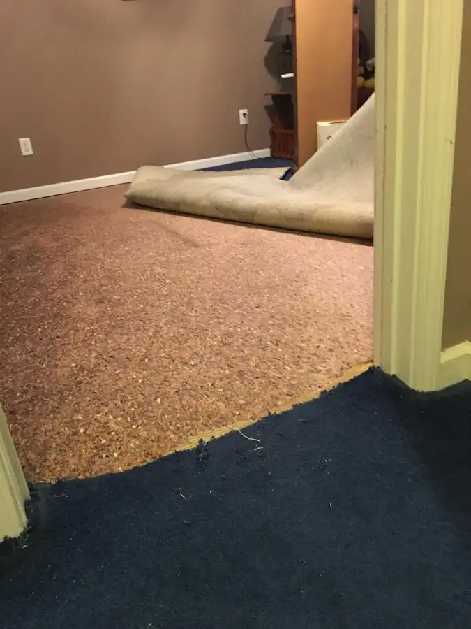 Carpet pad removal revealing water damage during Drying & Dehumidification in Mason City